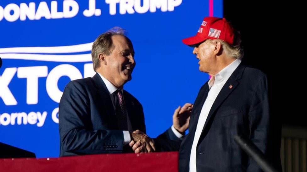 Texas Attorney General Ken Paxton greets former US President Donald Trump at the 'Save America' rally on October 22, 2022