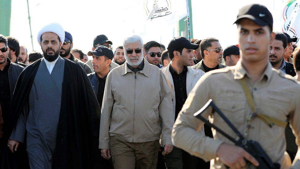 Image shows Abu Mahdi al-Muhandis (centre)