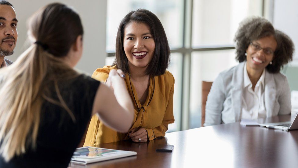 A man and women at an office meeting