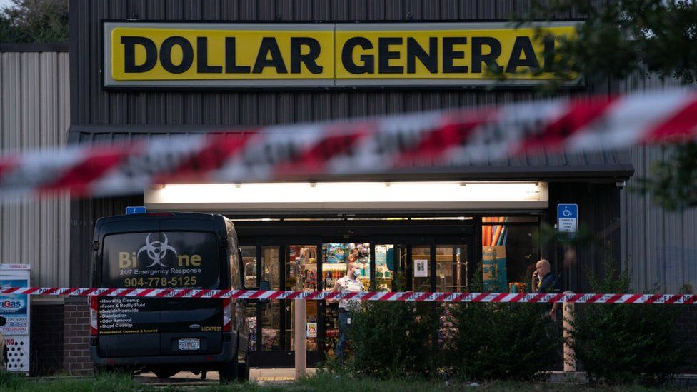 A biohazard cleanup vehicle is parked outside the Dollar General store where three people were shot and killed the day before