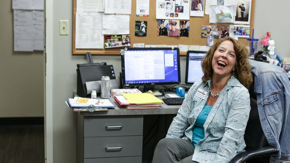 Rhonda Francis at her desk, smiling