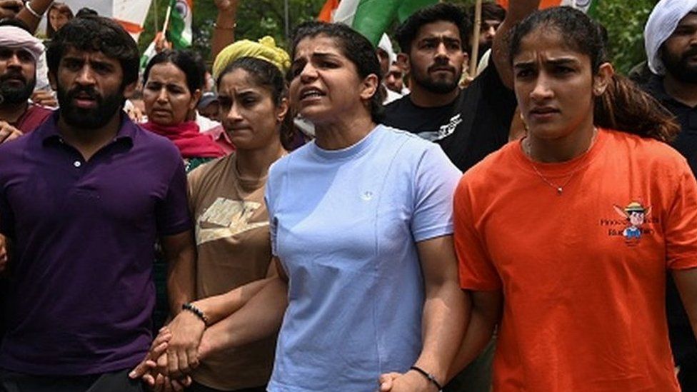 Wrestlers Bajrang Punia, Sakshi Malik and Vinesh Phogat addressing a press conference during their ongoing protest against the Wrestling Federation of India chief Brij Bhushan Sharan Singh on May 26, 2023 in Delhi