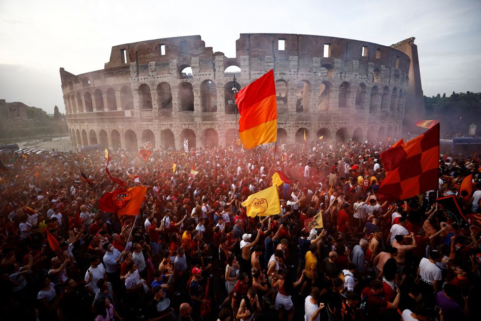 Football fans celebrate outside the Colosseum in Rome, Italy, on 26 May 2022