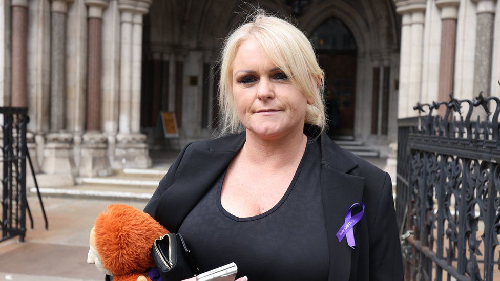 Hollie Dance, mother of Archie Battersbee, holding a soft toy and standing outside the High Court