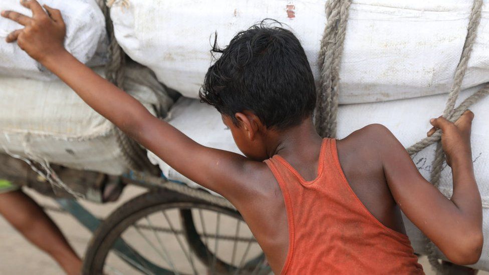 A child labourer pushing a rickshaw