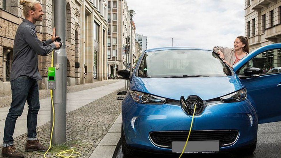 electric car plugged in to lamp-post