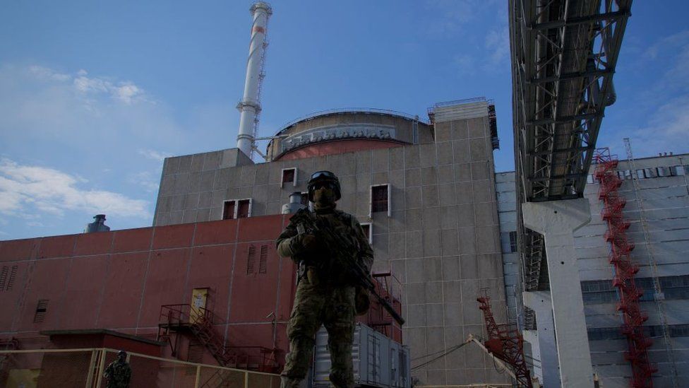 A Russian soldier stands guard outside Zaporizhzhia nuclear power plant