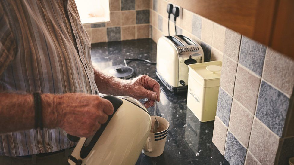 Man using electric kettle