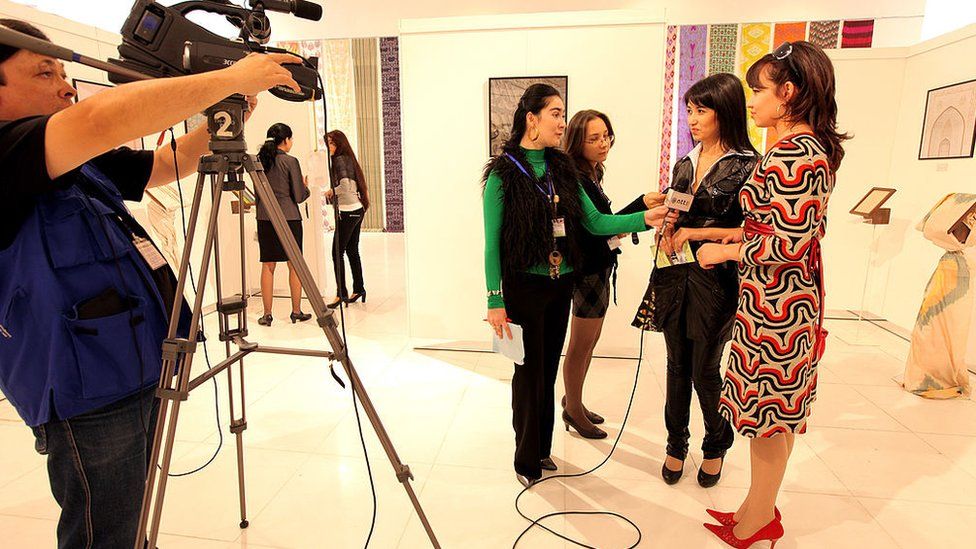 An Uzbek TV team films a design and fashion exhibition in Tashkent