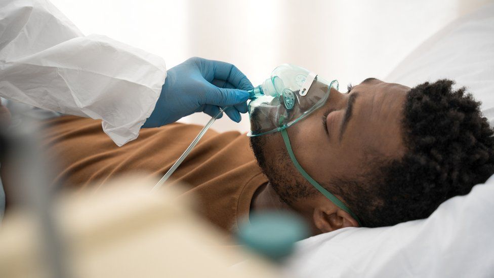 A man receives treatment through a ventilator