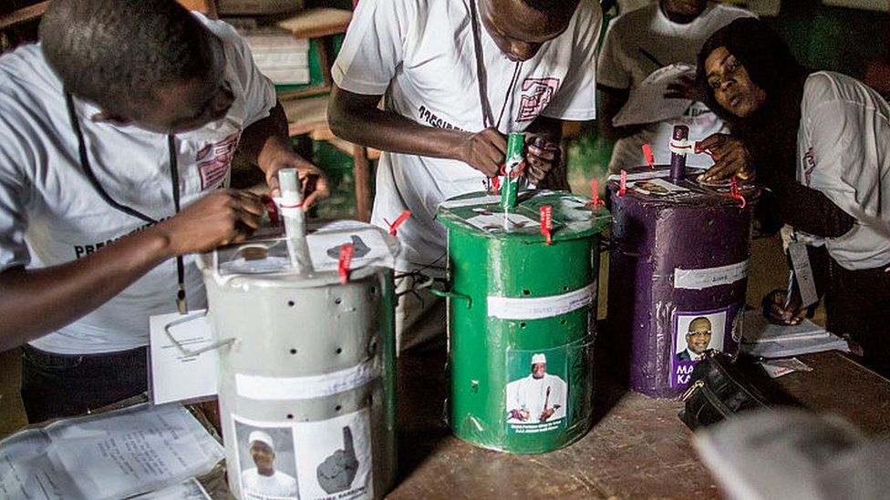 Polling officials check the seals on the voting drums at a polling station in Banjul on 1 December 2016
