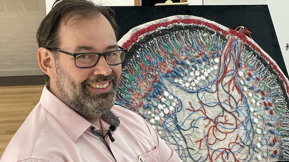 Prof Adrian Liston and a tactile retina map, created by Dr Erica Tandori