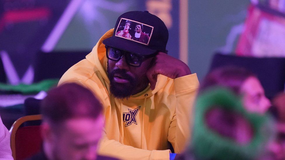 Derek Chisora watches the action during the final of the Paddy Power World Darts Championship at Alexandra Palace, London.