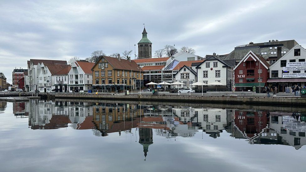 A line of buildings reflected in water