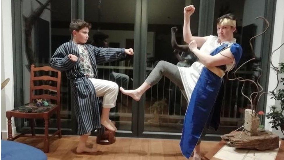 Two people dressed up doing karate