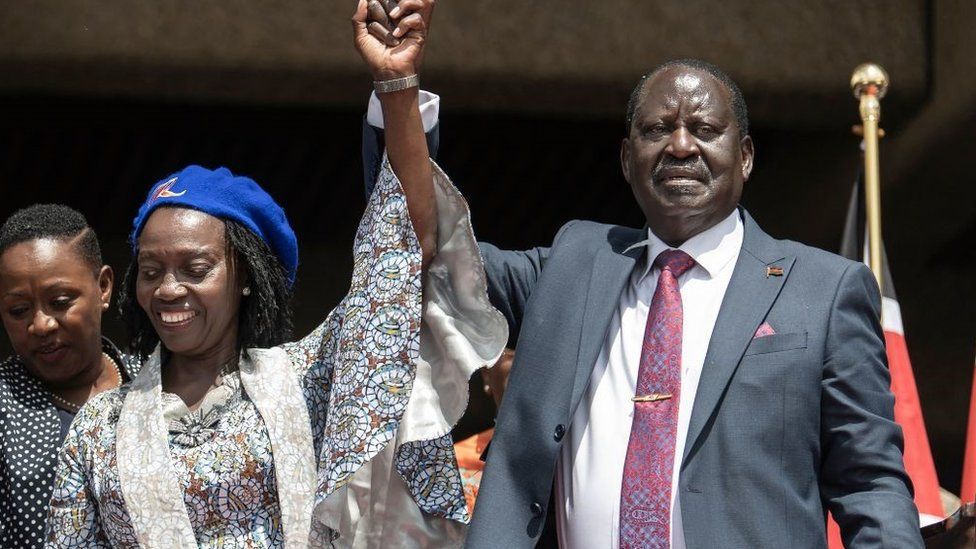 Azimio coalition presidential flag-bearer, Raila Odinga (R), raises the arm of his newly announced running mate, Martha Karua (L), in Nairobi on May 16, 202