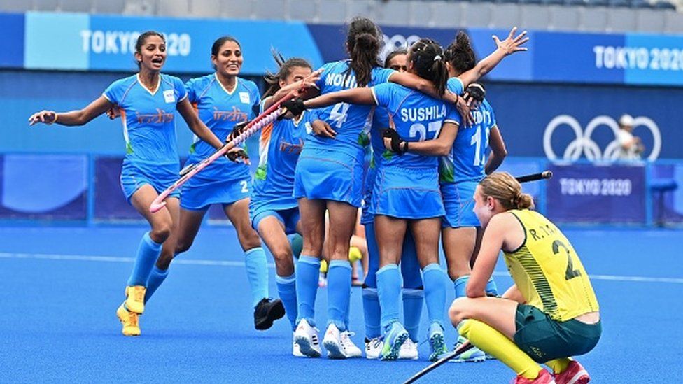 Players of India celebrate after defeating Australia 1-0 in their women's quarter-final match of the Tokyo 2020 Olympic Games field hockey competition.