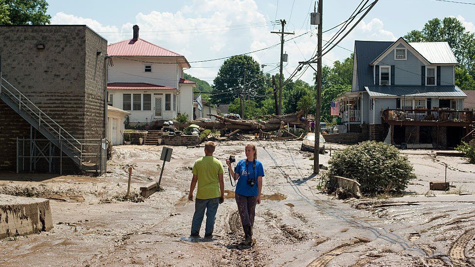 Residents survey Clendenin, West Virginia after the Elk River overflowed on 25 June 2016
