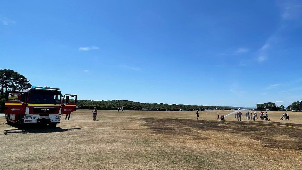 A fire engine and officers putting out a fire