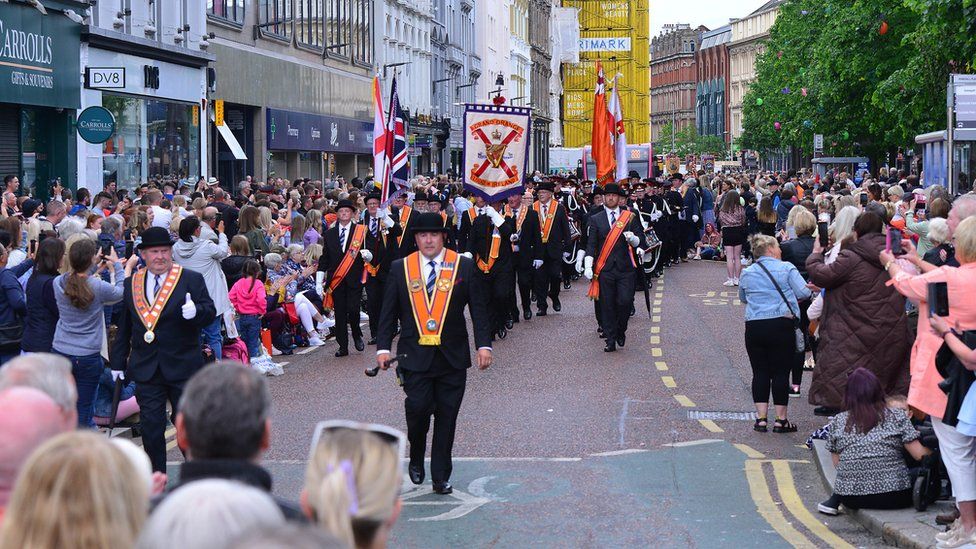 Orange Order members marching down Donegall Place in the city centre