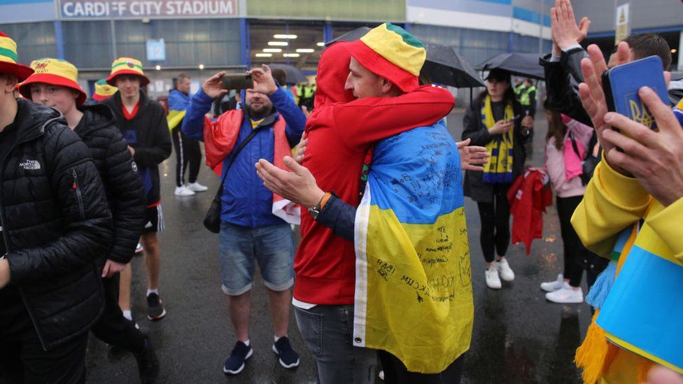 Wales and Ukraine fans embrace