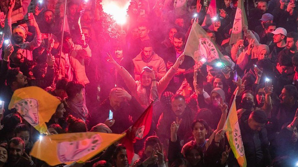 Supporters of the pro-Kurdish Peoples' Equality and Democracy Party (DEM) celebrate after the Supreme electoral Board (YSK) changed their decision