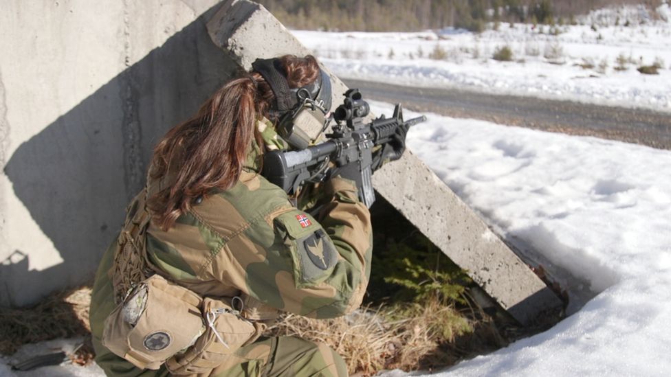 Female soldier fires gun