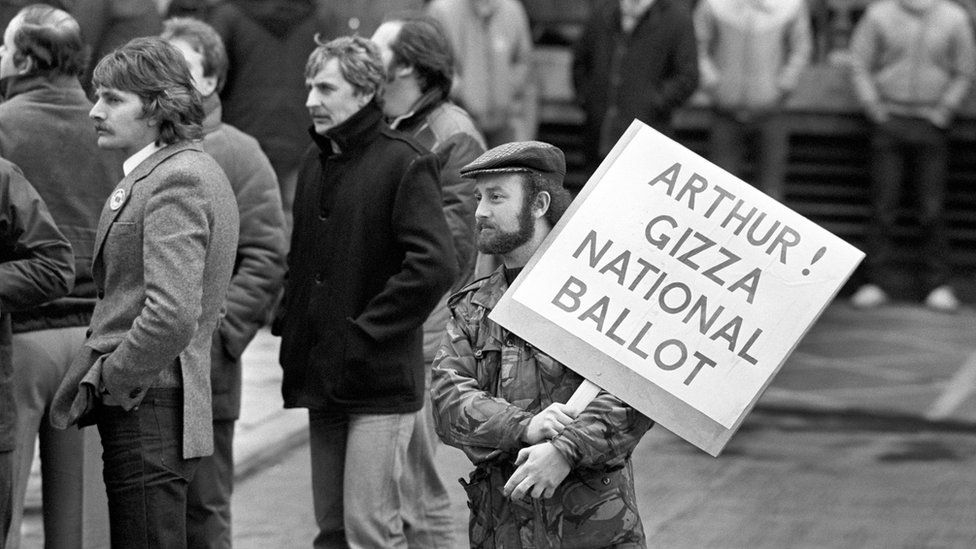 A Leicester miner from the Power Group holds a placard addressed to National Union of Miners President Arthur Scargil, outside the NUM"s Sheffield headquarters when Scargill spoke to the Leicester miners.