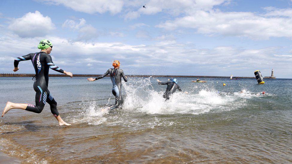 Participants enter the water at Roker for the swim leg of the triathlon events