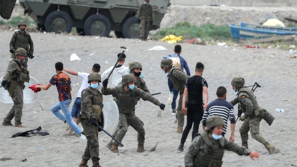 A Spanish soldier hits a Moroccan citizen at El Tarajal beach, near the fence between the Spanish-Moroccan border