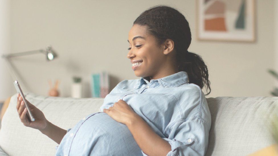 Pregnant woman looking at phone