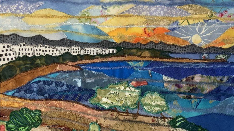 A patchwork artwork of the sea and a row of white houses