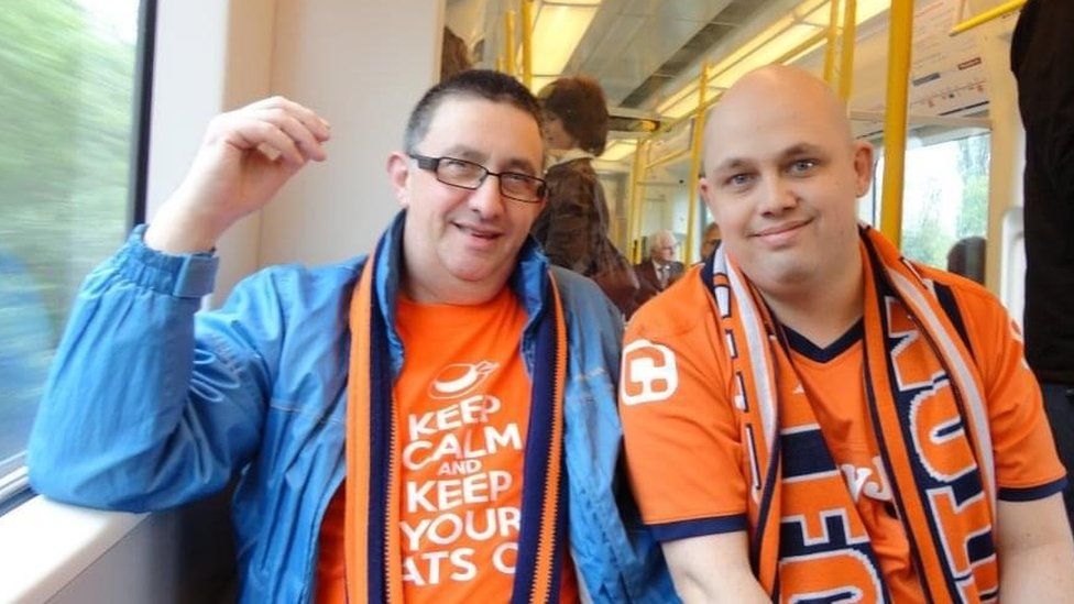 Richard Armstrong (right) and his father Calvin in their Luton Town shirts on the way to a game