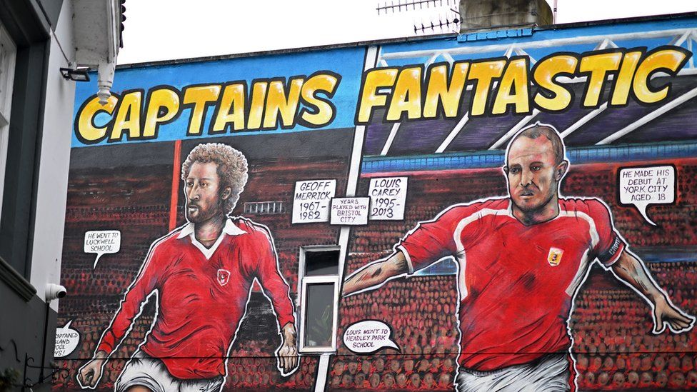 A mural on the side of a building showing two Bristol City players
