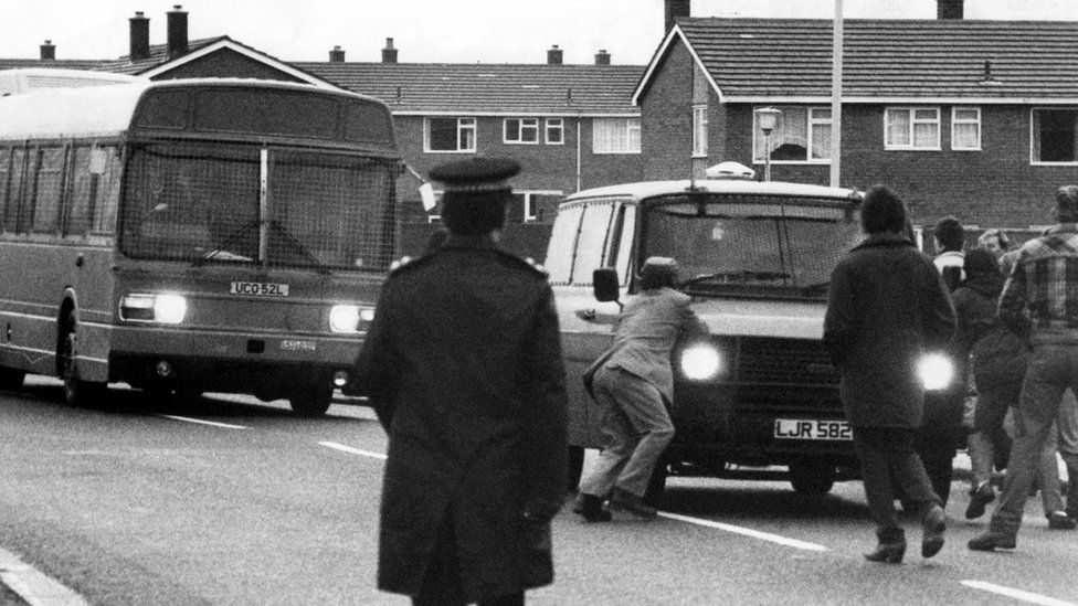 Picketers attempt to stop a bus carrying working miners to Ellington colliery in Northumberland