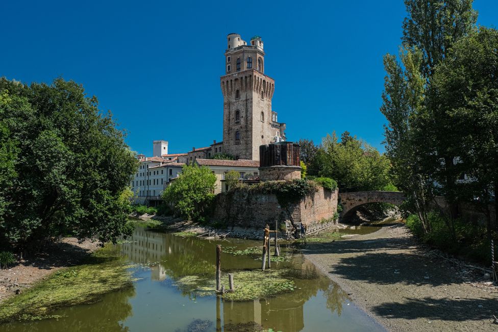 A tributary of the Bacchiglione di Padova, with the Specola in the background, Padua, Italy.