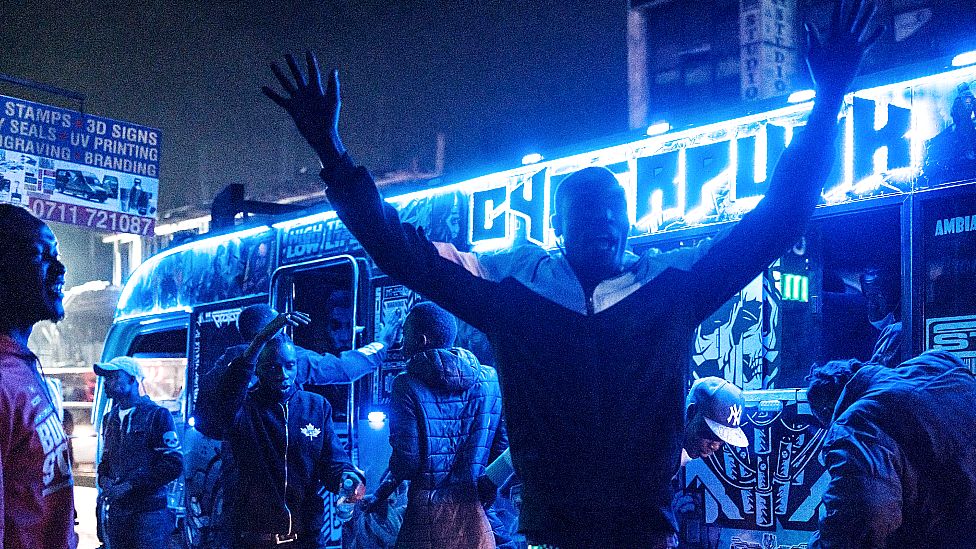 A matatu operator calls for passengers late at night in Nairobi, Kenya - Thursday 21 October 2021