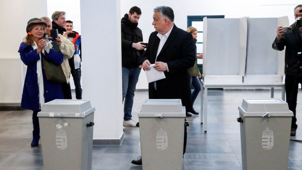 Hungarian Prime Minister Viktor Orban holds his ballot paper, at a polling station during the Hungarian parliamentary election, in Budapest, Hungary, April 3, 2022