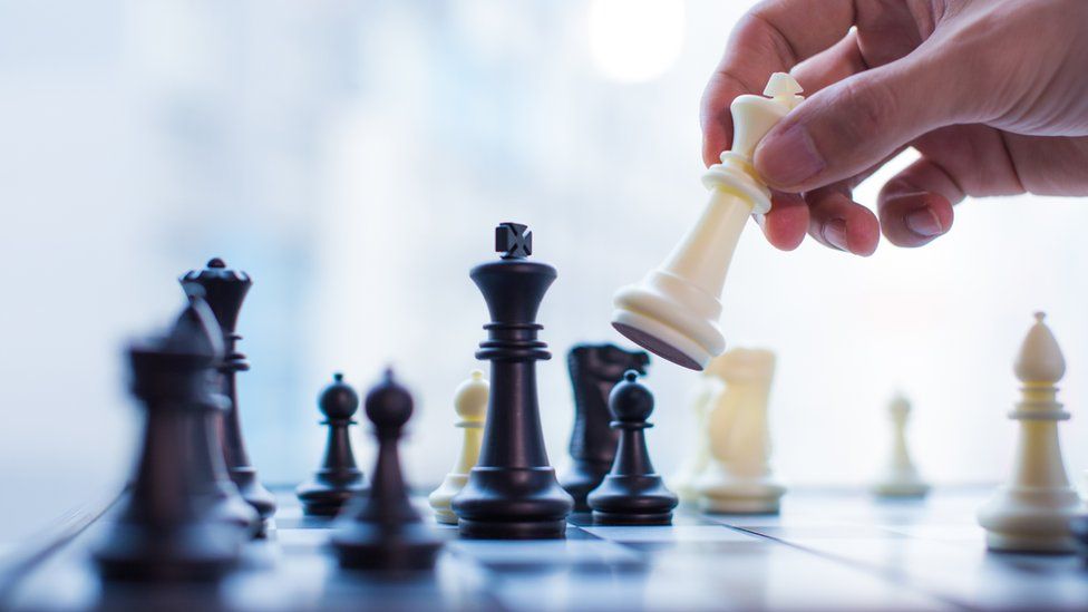 A chessboard with black and white players.