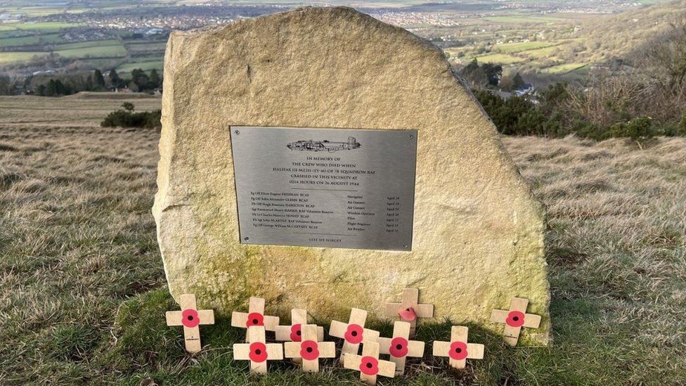 The memorial erected on Cleeve Hill, made of stone from the nearby Common quarry. There are small crosses with poppies laid at its base.