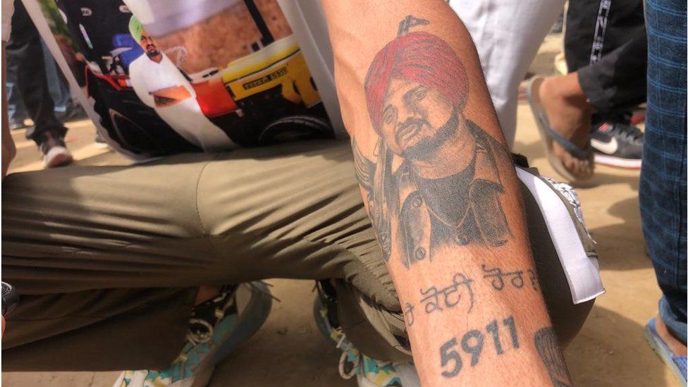A fan shows his Sidhu Moose Wala tattoo