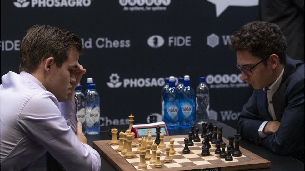 Magnus Carlsen, left, and Fabiano Caruana playing chess