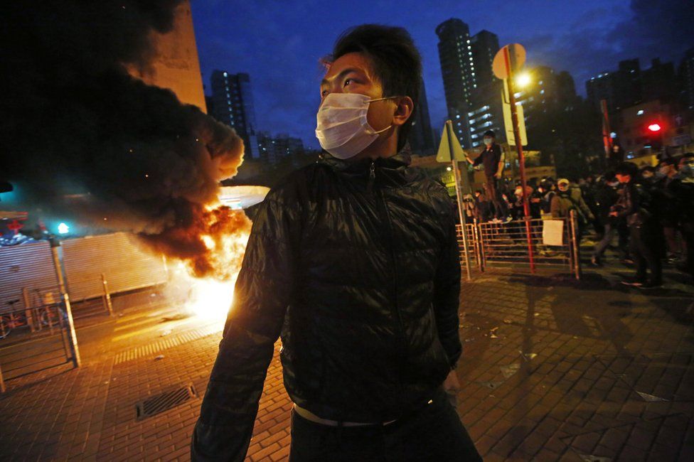 Smoke rises as protestors set fires on a street in Mong Kok district of Hong Kong, Tuesday, 9 February 2016.