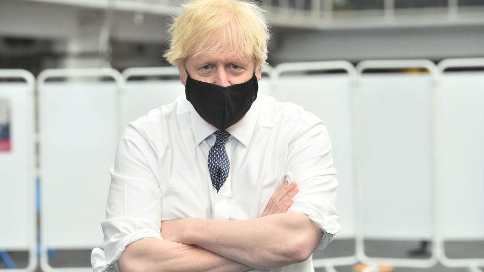 Boris Johnson wears a face mask while visiting a Vaccination Centre at the Business Design Centre in Islington on May 18, 2021