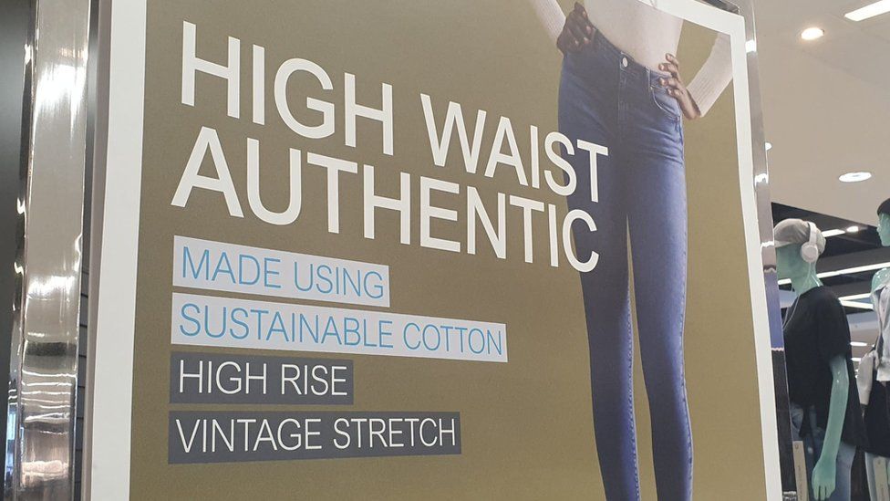 pictures-shows-sign-in-clothes-shop-with-a-woman-wearing-jeans-that-are-made-of-sustainable-cotton