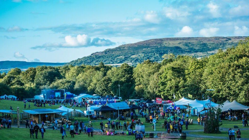 Festival surrounded by trees and hills