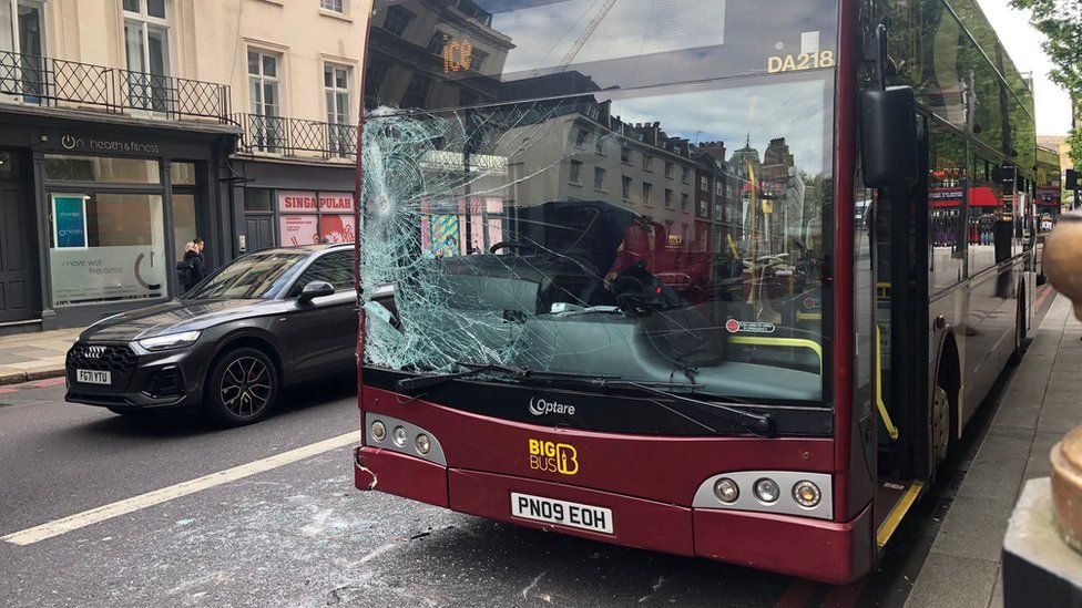Photo showing smashed glass on a tour bus near the scene of the collision with a horse in London