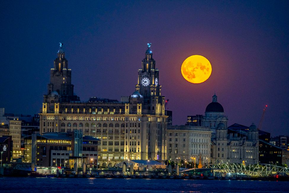 The moon glows over the Royal Liver Building in Liverpool
