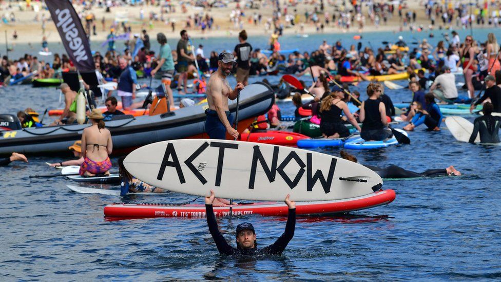 Protesters take part in a paddle out, organised by Surfers Against Sewage, on Gyllyngvase Beach near Falmouth, during the G7 summit in Cornwall.