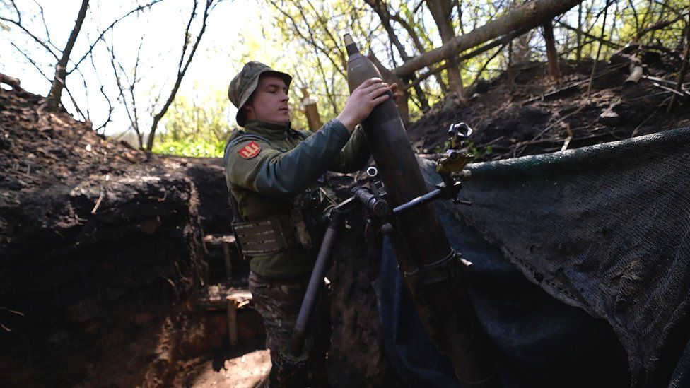 A 120mm mortar is loaded into a launching device in Eastern Ukraine